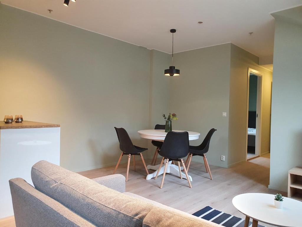 a living room with a couch and a table at Kong Oscars Apartments in Bergen