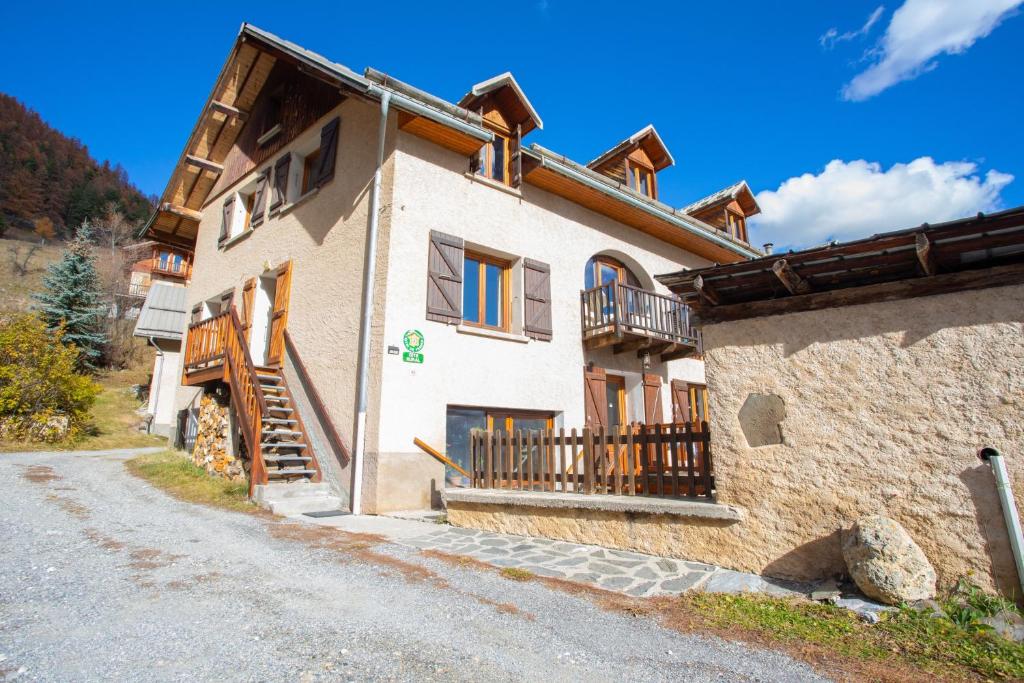 a house with a staircase on the side of it at Appartement de 2 chambres avec jardin et wifi a Arvieux a 1 km des pistes in Arvieux
