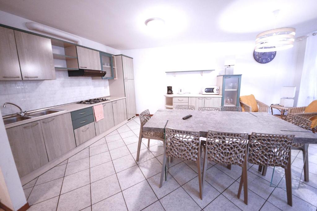 a kitchen with a table and chairs in a room at Best Location in Riva del Garda