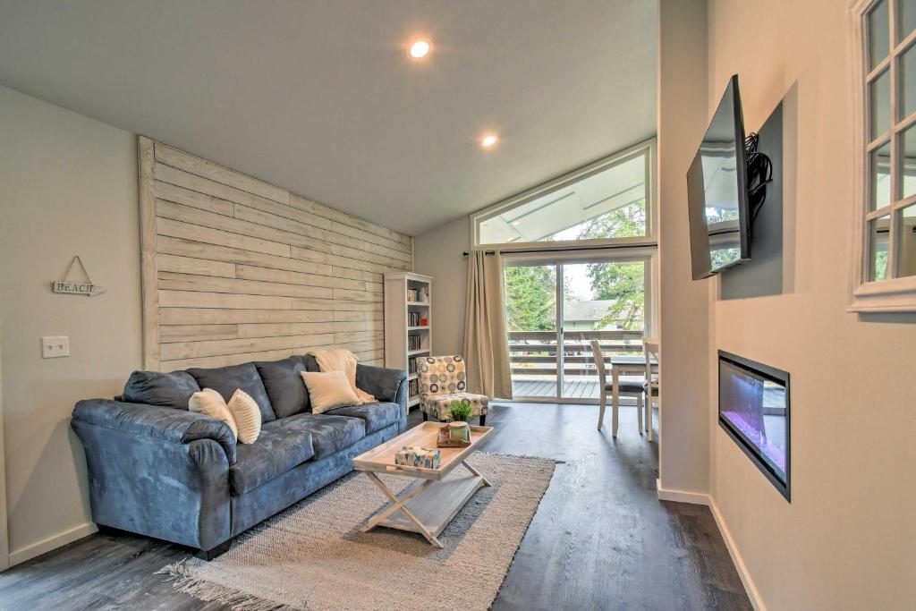 a living room with a couch and a table at Cozy Cottage on the Coast Near Downtown Westport! in Westport