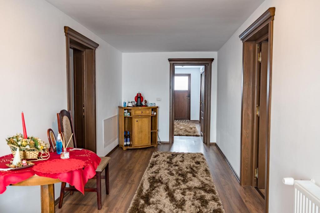 a room with a table with a red table cloth on it at Cabana Nemtisor in Nemţişor