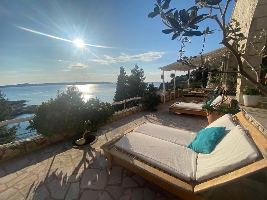 a bed on a patio with a view of the water at Villa Marijam in Hvar