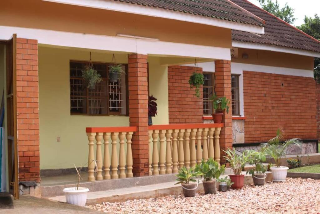 a house with a fence in front of it at House 1759, near River Nile in Jinja