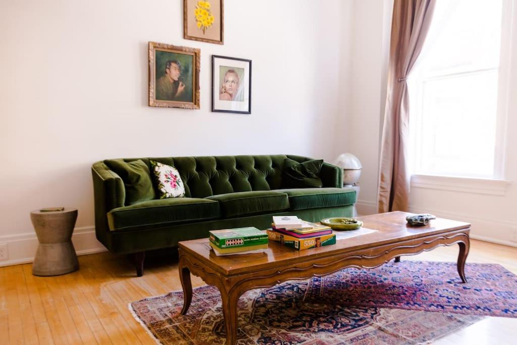a living room with a green couch and a coffee table at Object Hotel 2BR Room 2B in Bisbee