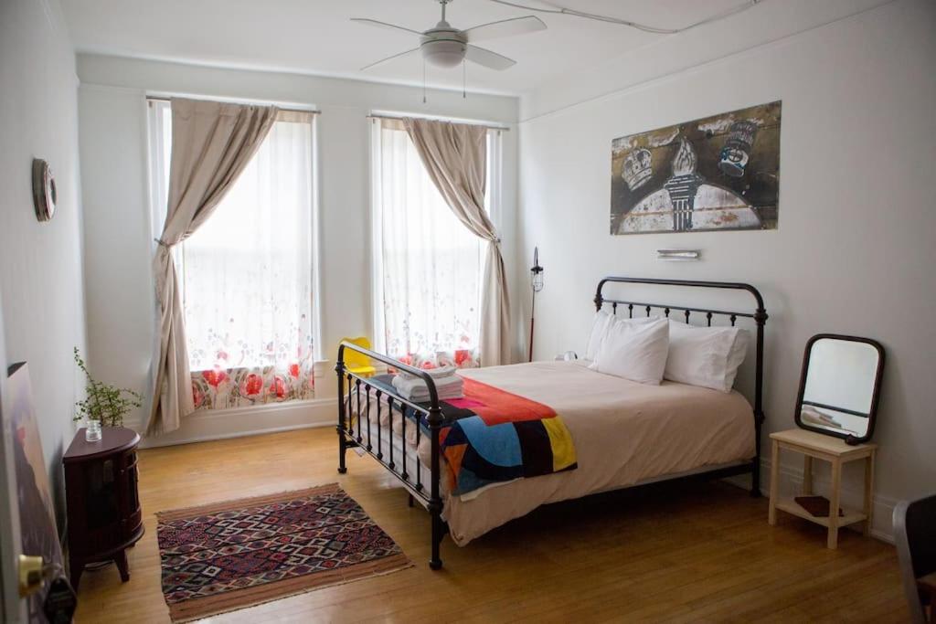 a bedroom with a bed and two windows at Object Hotel 1BR Shared Bath Room 2C in Bisbee