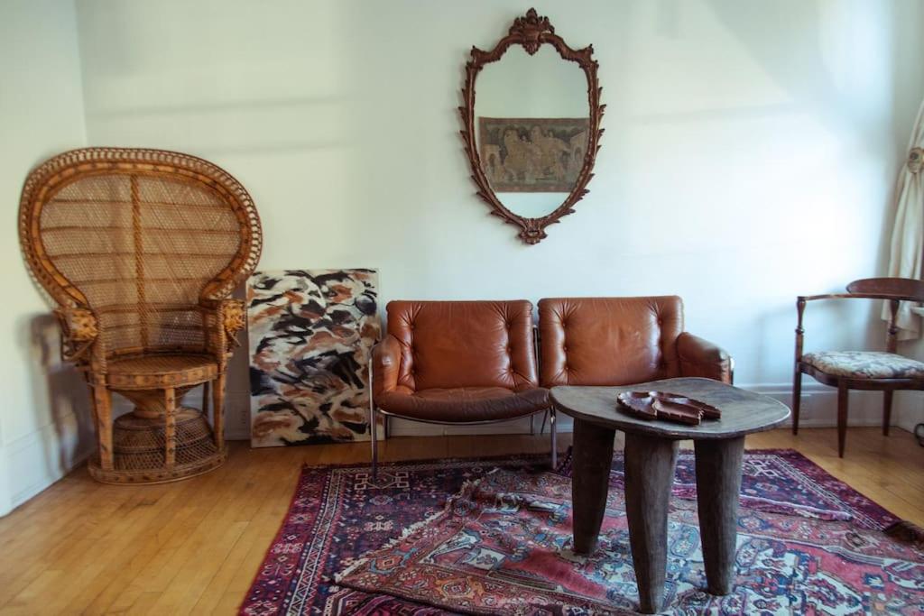 a living room with a couch and a table and a mirror at Object Hotel 1BR Room 3A in Bisbee