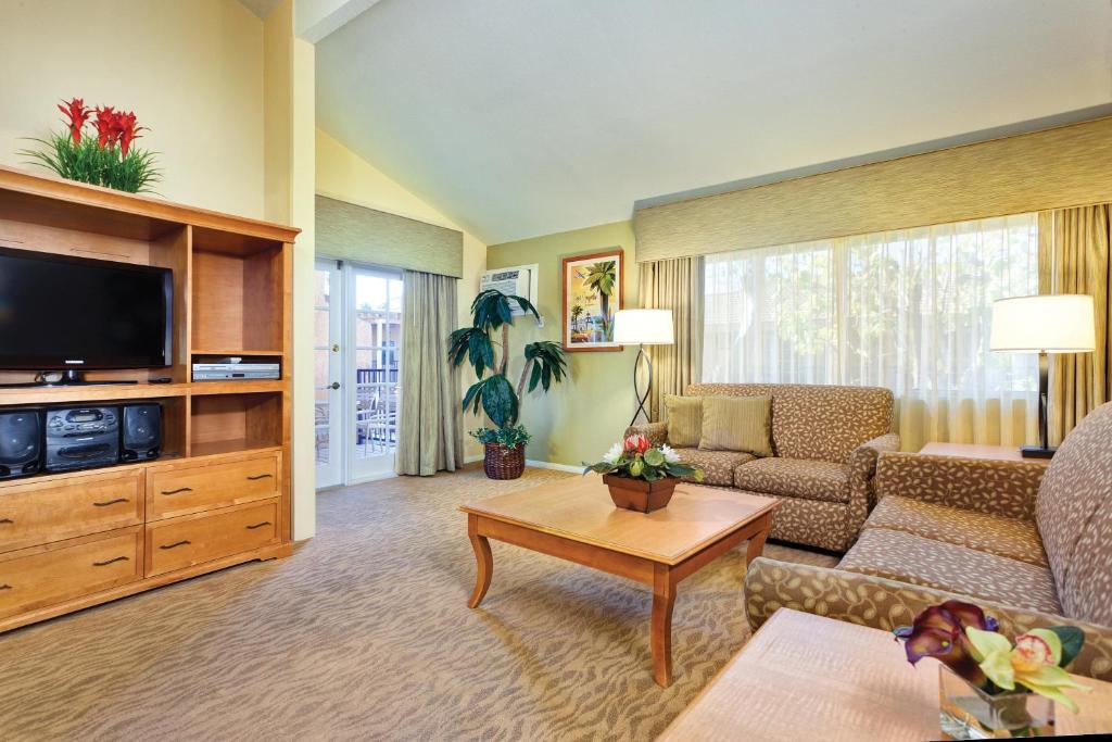 a living room with a couch and a tv at Club Wyndham Dolphin's Cove in Anaheim