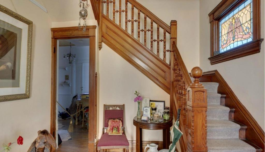 a staircase in a home with a stained glass window at Garden House Bed and Breakfast in Hannibal