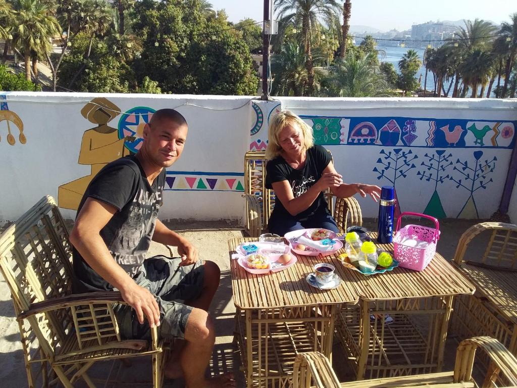 a man and a woman sitting at a table at Roma House in Aswan