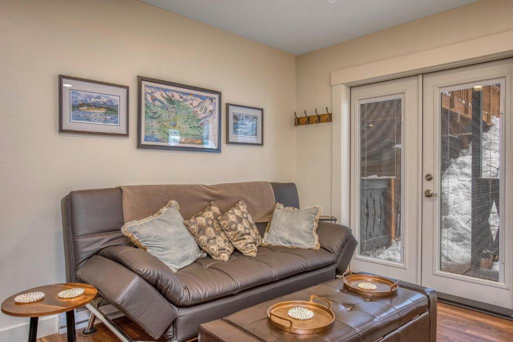 a living room with a brown couch and a table at East Condo #202 in Girdwood