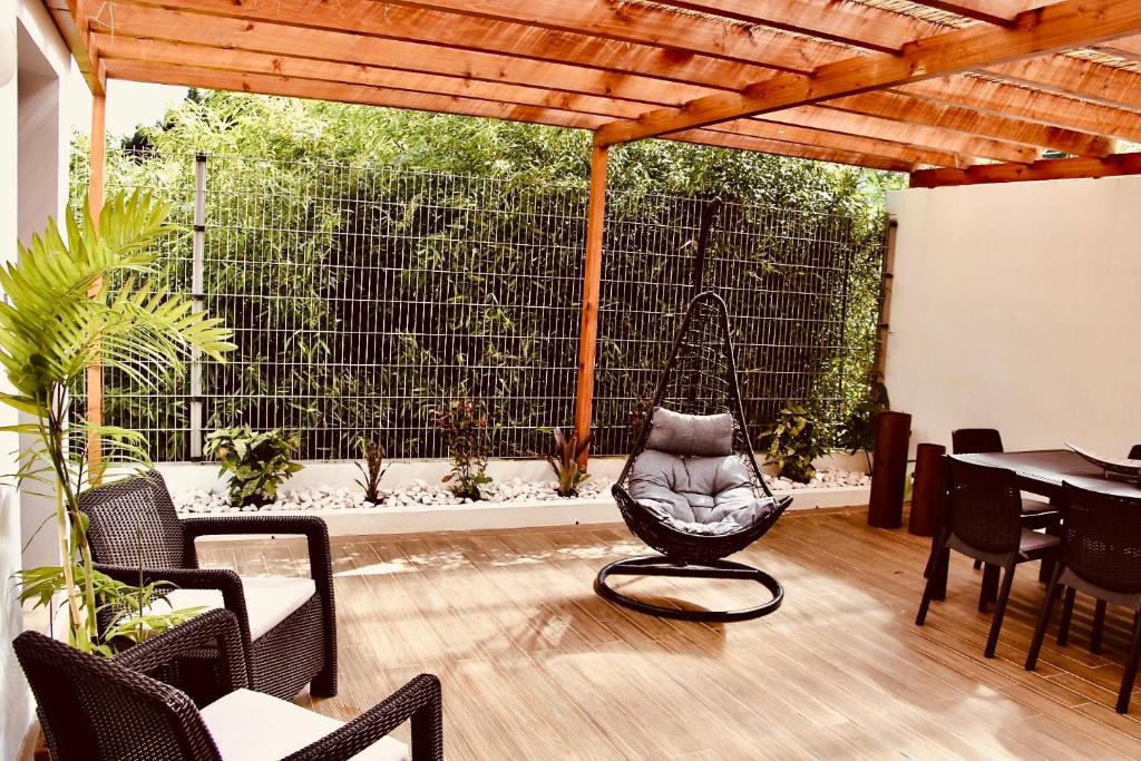 patio z krzesłem, stołem i ogrodzeniem w obiekcie InSide Furnas w mieście Furnas