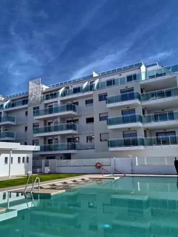 a building with a swimming pool in front of it at Apartamento Duna Beach in Torrox