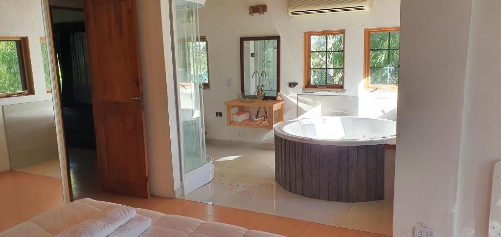 a large bathroom with a tub and a sink at AMANU Casa Unica en el delta de Tigre a solo 5' para 25 personas in Tigre
