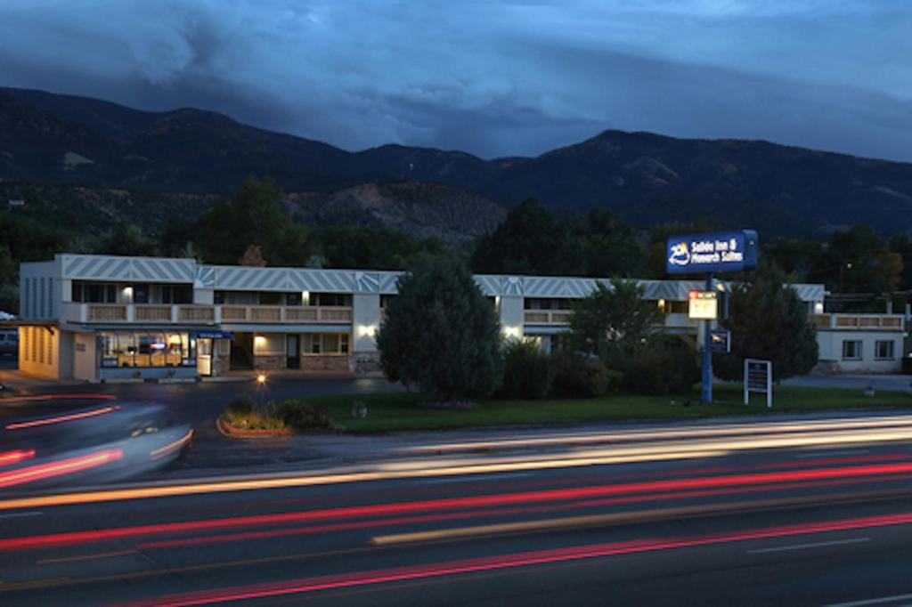 a building on a city street at night at Salida Inn & Monarch Suites in Salida