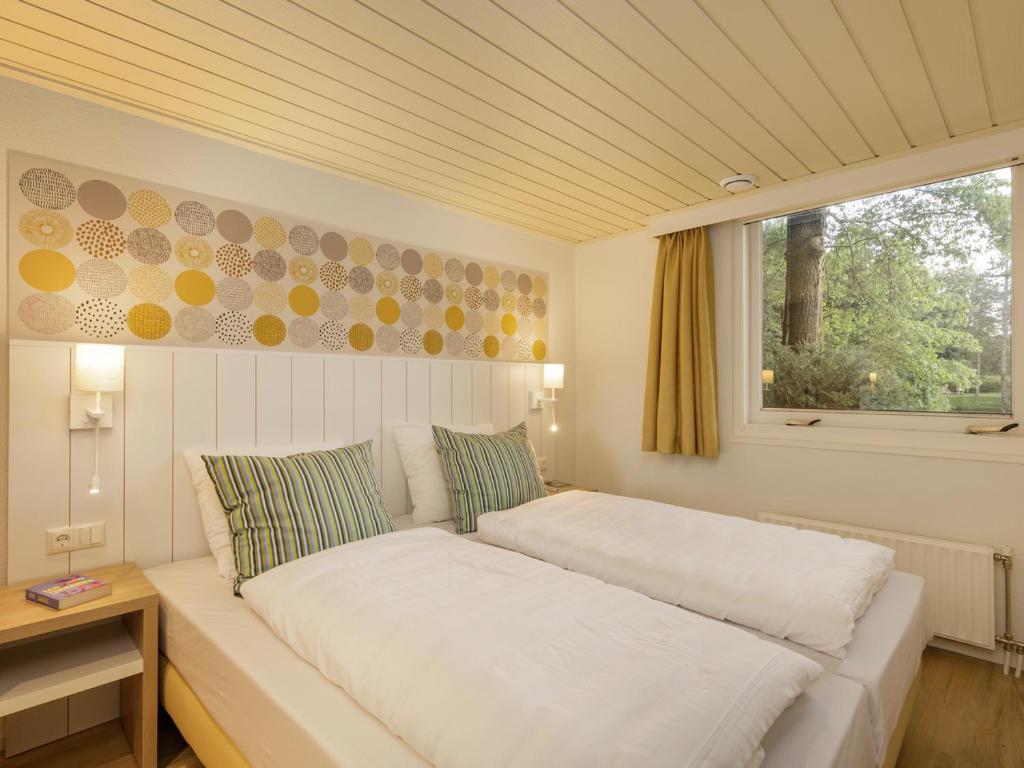 Postel nebo postele na pokoji v ubytování Center Parcs De Eemhof