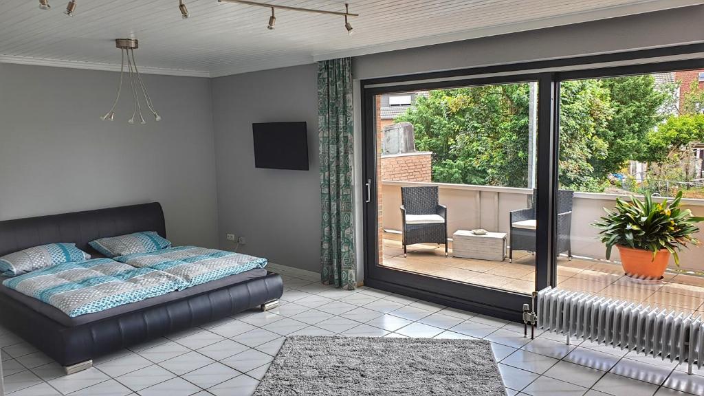 a bedroom with a bed and a sliding glass door at Appartement mit Weitblick in Mönchengladbach