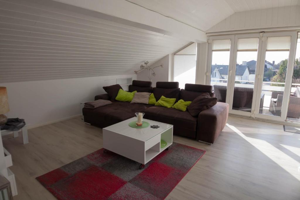 a living room with a couch and a coffee table at Ferienwohnung in Süddeutschland (D-CH-F) in Fischingen