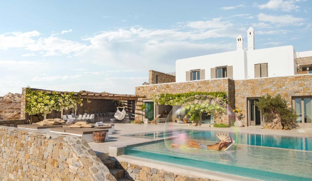 a villa with a swimming pool and a house at Villa Fleur De Sel in Fanari