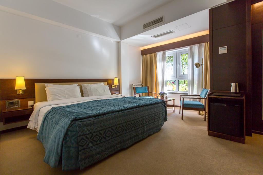 a hotel room with a bed and a window at Hotel Sao Jose in Fátima