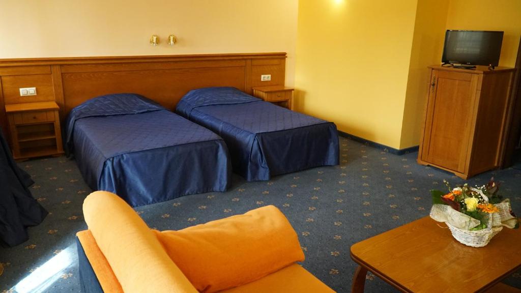 Postel nebo postele na pokoji v ubytování Troyan Plaza Hotel