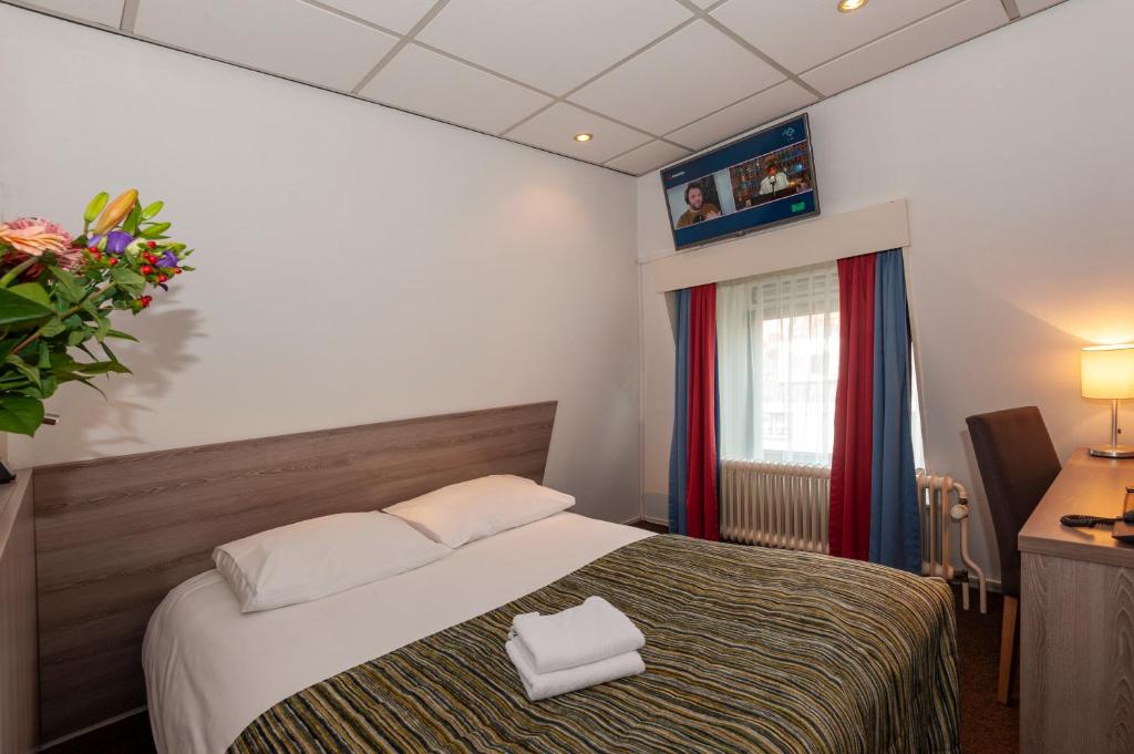 Postel nebo postele na pokoji v ubytování Hampshire Hotel Petit Nord