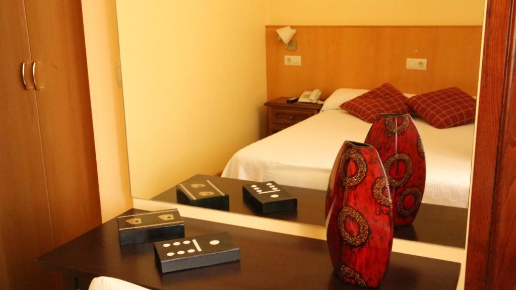 A bed or beds in a room at Hostal Antolín
