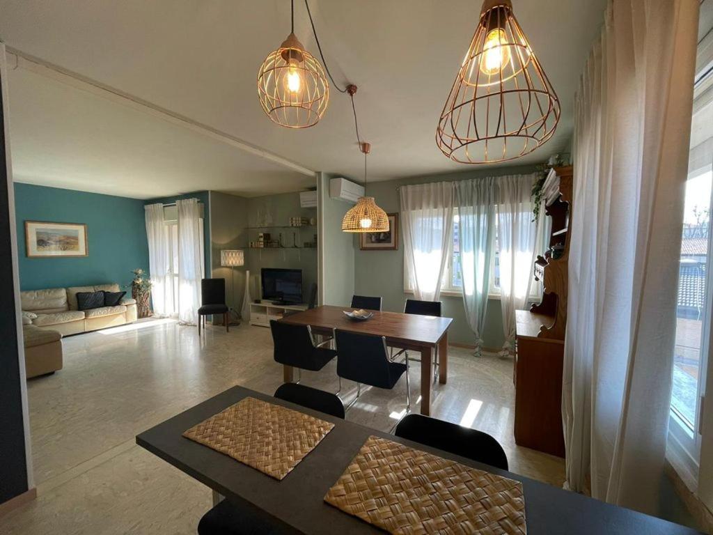 a living room with a table and chairs and a dining room at Villa Irene Apartments in Mestre