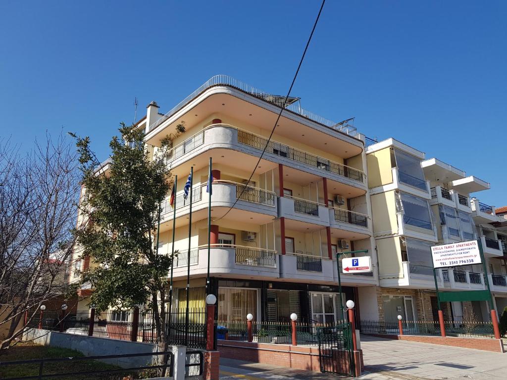 a large building on the corner of a street at Stella Family Apartments in Síndos