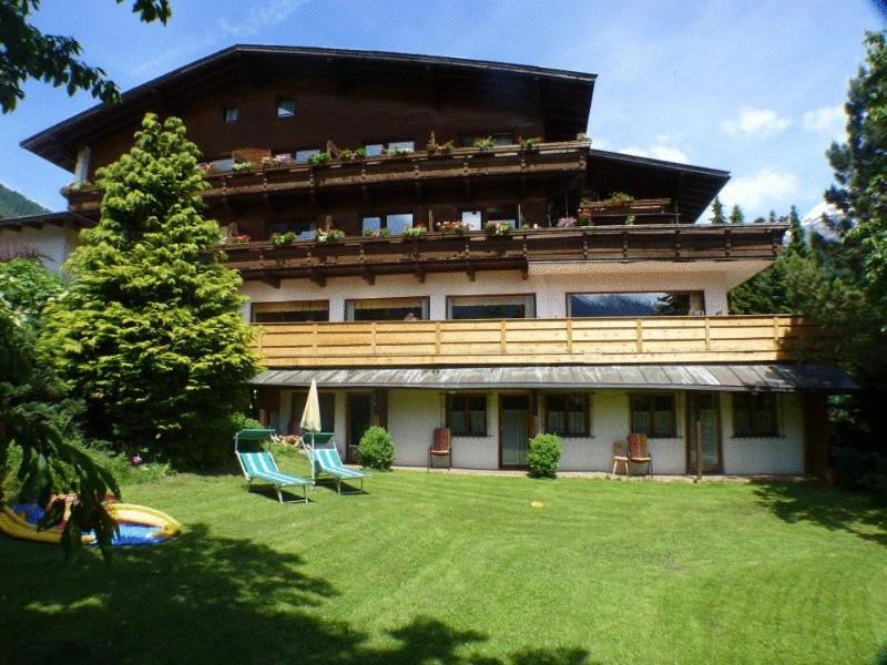 a large building with a lawn in front of it at Hotel Rogen in Neustift im Stubaital