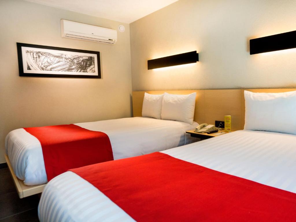 Postel nebo postele na pokoji v ubytování City Express Plus by Marriott Cali Colombia