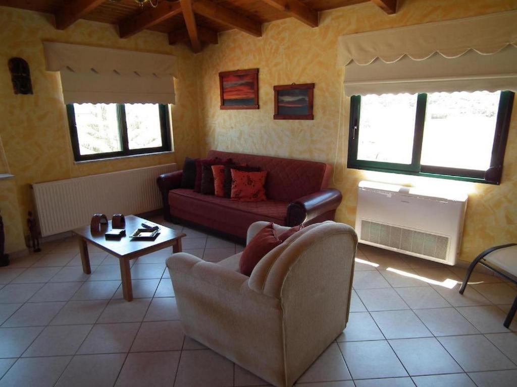 a living room with a couch and a table at Gramvoussa Bay in Kissamos