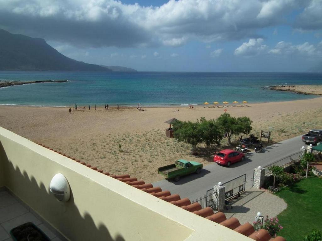 a view of a beach with a red car on it at Gramvoussa Bay in Kissamos