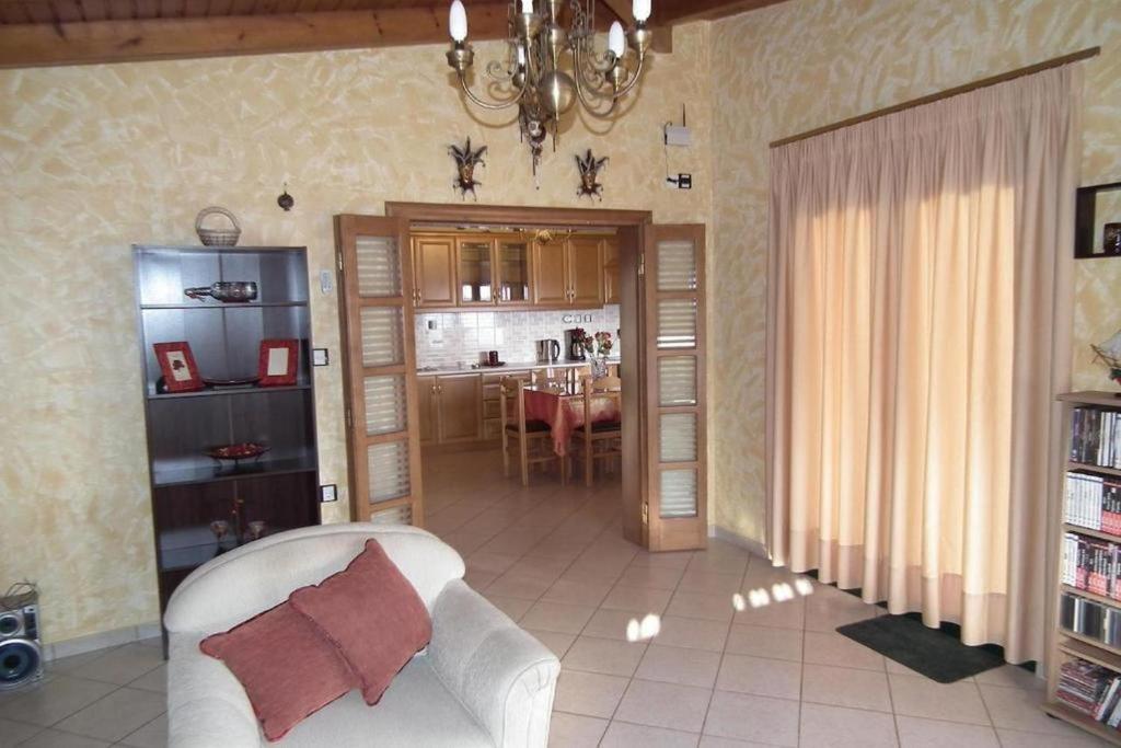 a living room with a couch and a dining room at Gramvoussa Bay in Kissamos