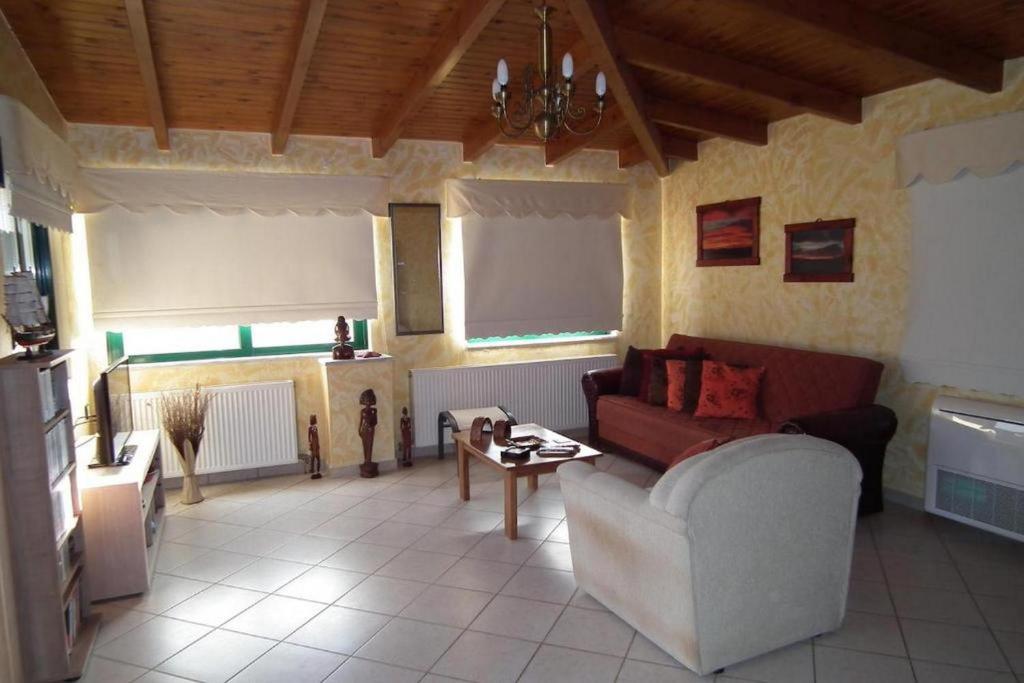 a living room with a couch and a table at Gramvoussa Bay in Kissamos