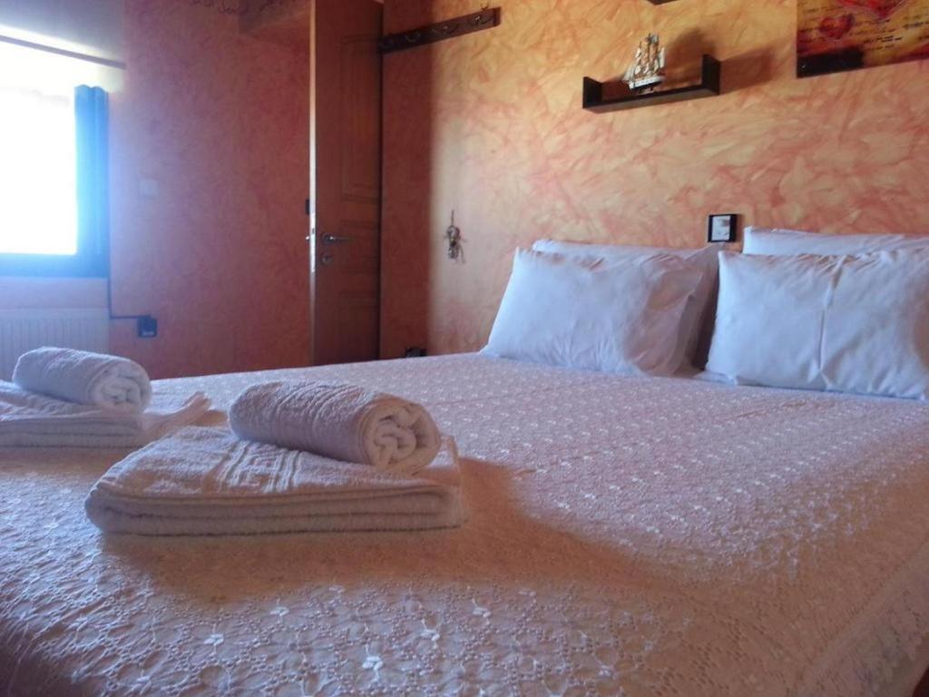 a bedroom with a bed with towels on it at Gramvoussa Bay in Kissamos