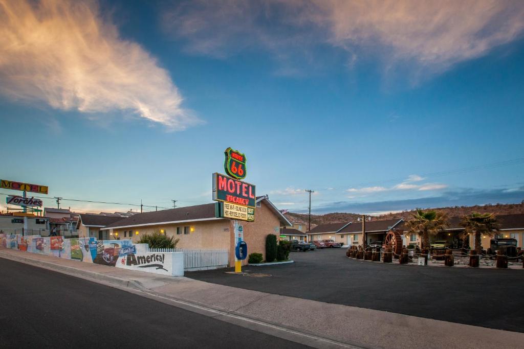 a hotel with a sign on the side of a street at Route 66 Motel in Barstow