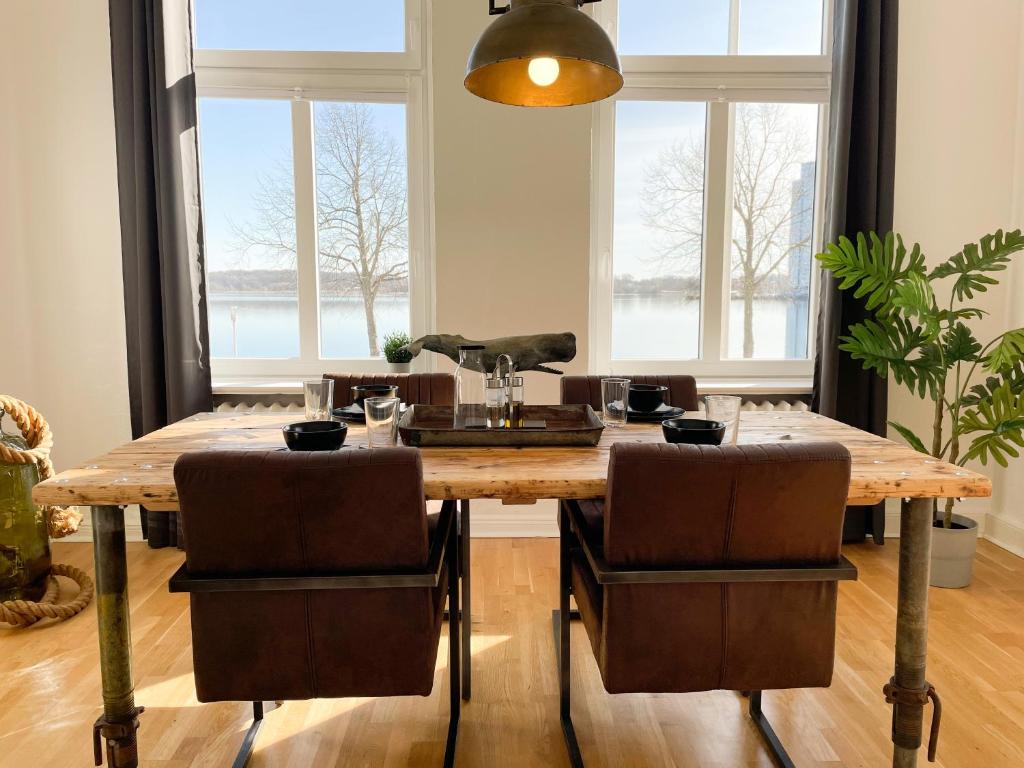- une salle à manger avec une table et des chaises en bois dans l'établissement Altbauwohnung mit Schleiblick - Erster Stock, à Schleswig