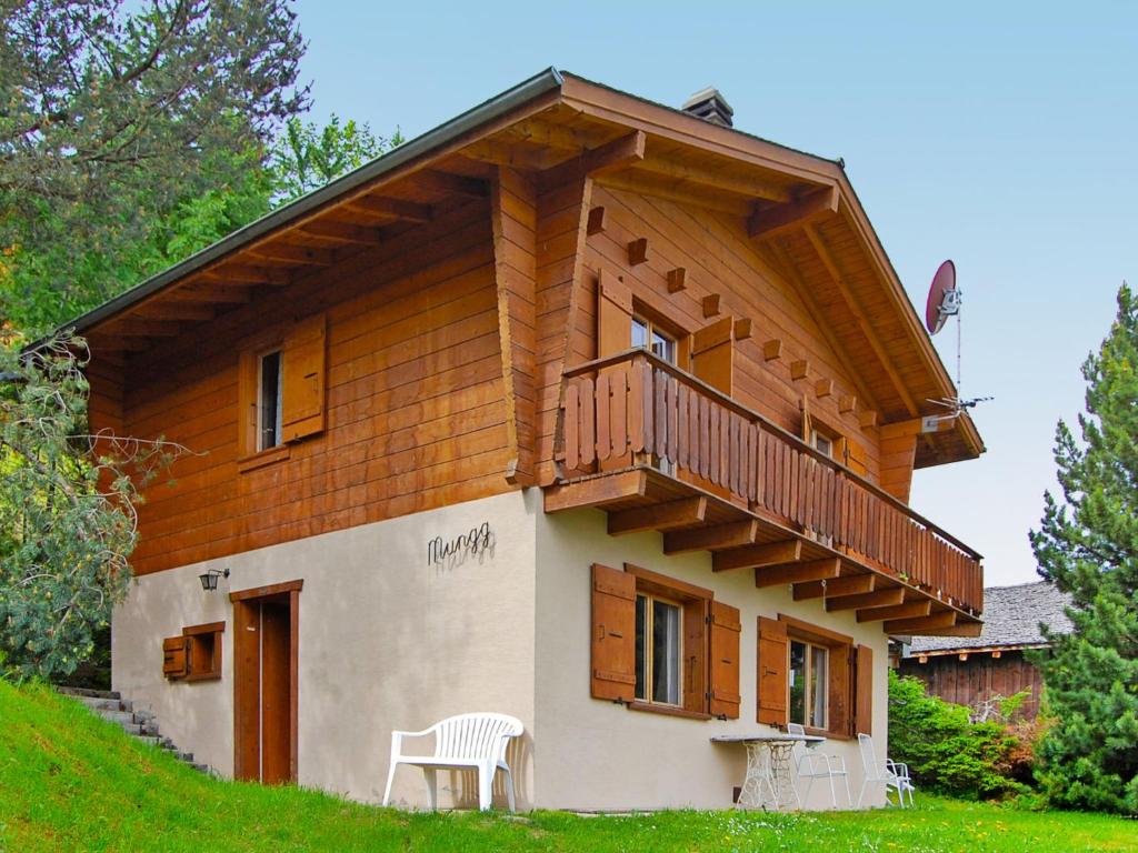 a house with a balcony on the side of it at Chalet Mungg by Interhome in Nendaz