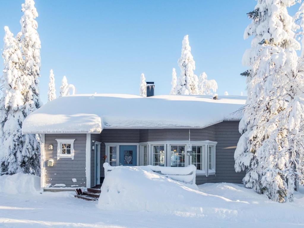 a small house in the snow with trees at Holiday Home Vuosselinhovi c by Interhome in Ruka