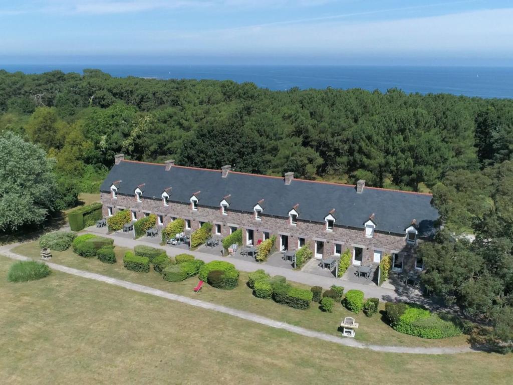 an aerial view of a large building with trees and the ocean at Holiday Home T3-Résidence La Carquois - CPF300 by Interhome in Frehel