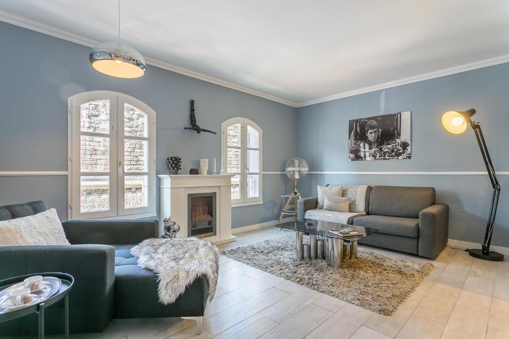 a living room with a couch and a fireplace at My Pad Provence 2 in Avignon