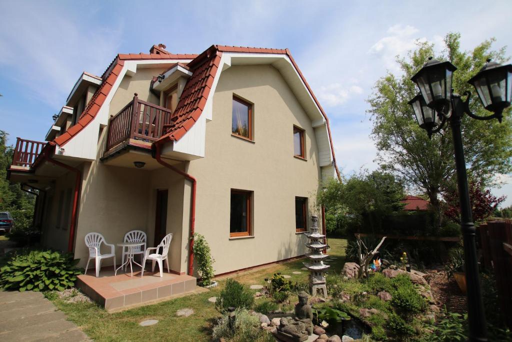 a house with a balcony and a table and chairs at Apartment 4 in Rewal