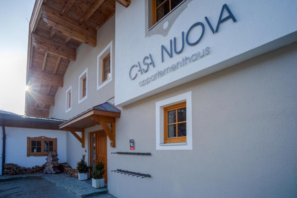 a building with a sign on the side of it at Appartements Casa Nuova in Saalbach-Hinterglemm