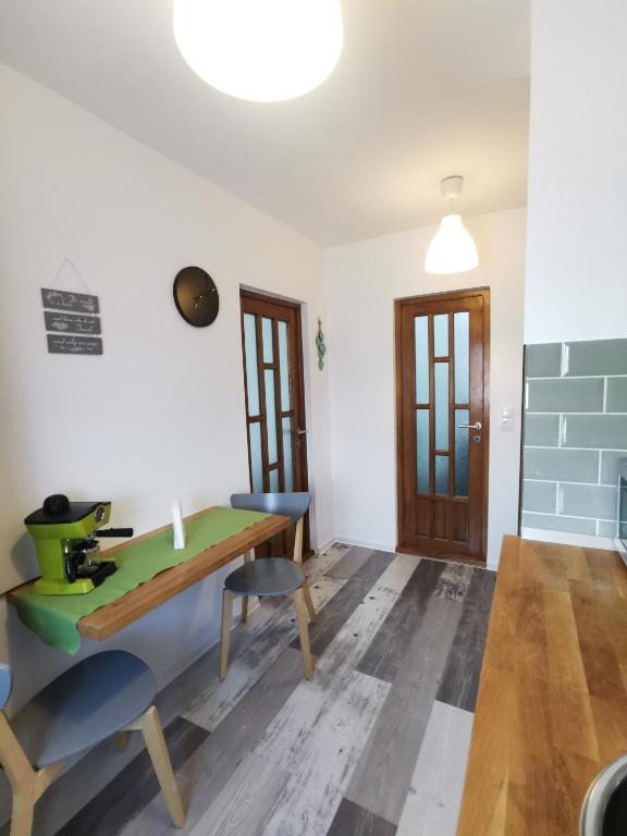 a dining room with a wooden table and chairs at Dream Studio Petrosani in Petroşani