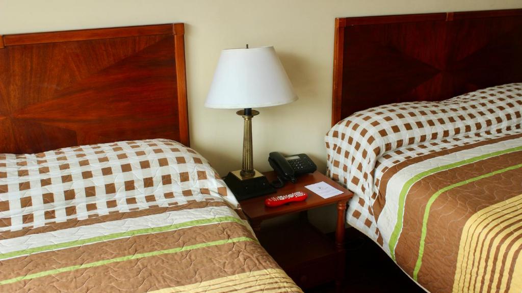 Postel nebo postele na pokoji v ubytování Hotel 6 De Diciembre