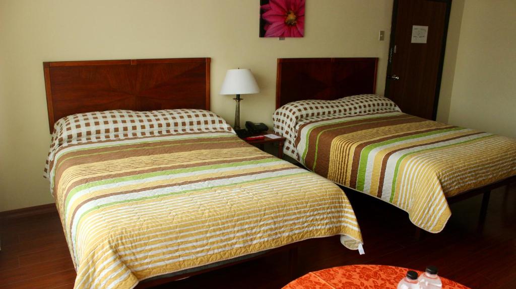 Postel nebo postele na pokoji v ubytování Hotel 6 De Diciembre