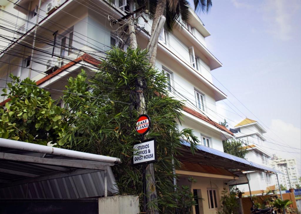 a no parking sign on a pole next to a building at East Coast in Trivandrum
