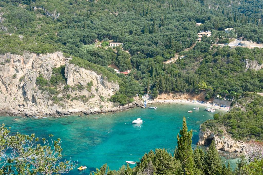 a view of a river with boats in the water at Zefiros Traditional Hotel in Paleokastritsa