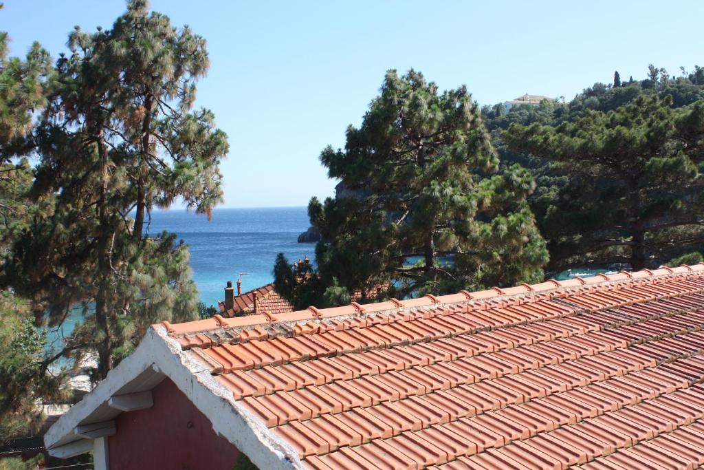 a roof of a house with a view of the ocean at Zefiros Traditional Hotel in Paleokastritsa