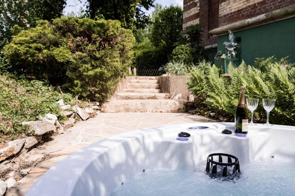 a table with a bottle of wine and two glasses at La Villa de l&#39;Etoile jacuzzi privé chauffé à 37°C in Forges-les-Eaux